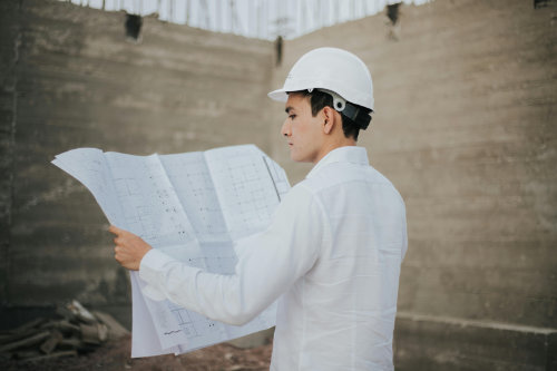 Construction professional reviewing blueprints